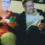 Two older adults on their smartphones