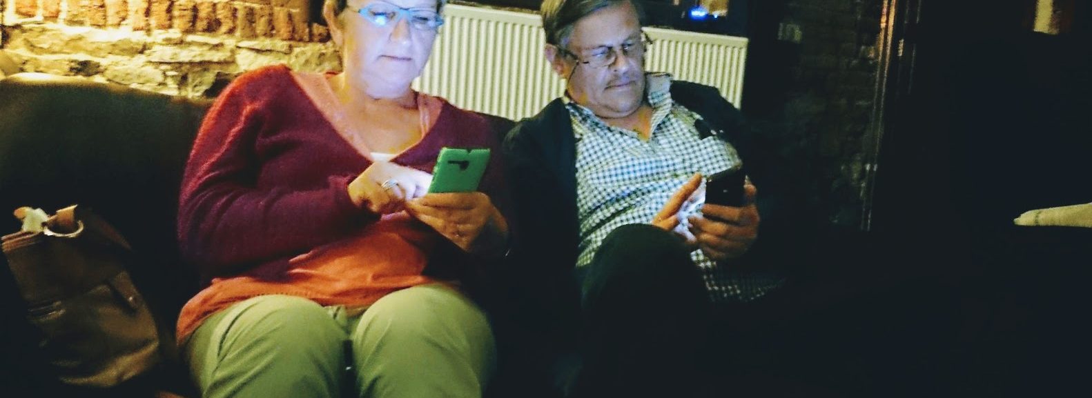 Two older adults on their smartphones